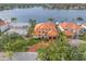 Exterior view of the home showcasing the red roof, three car garage, and well-manicured lawn at 301 Bayview Ne Dr, St Petersburg, FL 33704