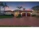 Beautiful Mediterranean-style home with a brick driveway, two-car garage, and lush landscaping at 301 Bayview Ne Dr, St Petersburg, FL 33704