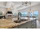 A gourmet kitchen island offers views of the living area and waterfront at 301 Bayview Ne Dr, St Petersburg, FL 33704