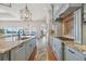 Gourmet kitchen featuring an island, granite countertops, custom cabinets, and stainless steel appliances at 301 Bayview Ne Dr, St Petersburg, FL 33704