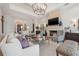 Bright living room with coffered ceilings, stone fireplace, TV and elegant furnishings at 301 Bayview Ne Dr, St Petersburg, FL 33704
