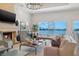 Cozy living room with a fireplace, water views, and comfortable seating at 301 Bayview Ne Dr, St Petersburg, FL 33704