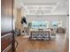 Open-concept living room and dining area with a fireplace and water views at 301 Bayview Ne Dr, St Petersburg, FL 33704