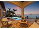 Tranquil outdoor patio featuring a covered seating area and pool with waterfront views at 301 Bayview Ne Dr, St Petersburg, FL 33704