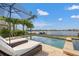 Outdoor shot of a waterfront pool, lounge chairs and umbrella for shade on a sunny day at 301 Bayview Ne Dr, St Petersburg, FL 33704