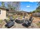 Expansive backyard featuring a fire pit with chairs, a cozy patio and landscaped gravel at 310 55Th S Ave, St Petersburg, FL 33705