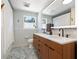 Bathroom featuring double sink vanity with sleek modern cabinets and a beautiful large mirror at 310 55Th S Ave, St Petersburg, FL 33705