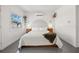 Bright bedroom featuring a large bed, hardwood floors, and modern decor, creating a cozy and inviting space at 310 55Th S Ave, St Petersburg, FL 33705