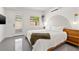 Bright bedroom featuring a large bed, hardwood floors, and modern decor, creating a cozy and inviting space at 310 55Th S Ave, St Petersburg, FL 33705