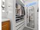 Walk-in closet with custom shelving and storage solutions and mirrors, providing ample space for organization at 310 55Th S Ave, St Petersburg, FL 33705