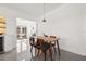 Dining room with modern table and views of the living room and outdoor space at 310 55Th S Ave, St Petersburg, FL 33705