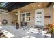 Charming front porch with patterned tiles, stylish seating, and freshly painted door at 310 55Th S Ave, St Petersburg, FL 33705