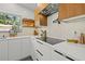 Modern kitchen featuring white cabinetry, wood accents, and stainless steel appliances at 310 55Th S Ave, St Petersburg, FL 33705