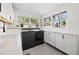 Modern kitchen featuring stainless steel appliances, white countertops, and ample cabinet space for storage at 310 55Th S Ave, St Petersburg, FL 33705