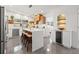 Modern kitchen with sleek white cabinetry, an island with seating, and stainless steel appliances at 310 55Th S Ave, St Petersburg, FL 33705