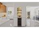 Open concept kitchen with built in wine storage and adjacent wine bar area at 310 55Th S Ave, St Petersburg, FL 33705