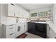 Modern kitchen featuring stainless steel appliances, white countertops, and ample cabinet space for storage at 310 55Th S Ave, St Petersburg, FL 33705