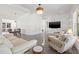 Spacious living room with views of the kitchen, dining room and a television mounted on the wall at 310 55Th S Ave, St Petersburg, FL 33705