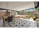 Inviting covered patio featuring stylish tile flooring, a dining table, and cozy seating area at 310 55Th S Ave, St Petersburg, FL 33705