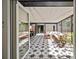 Spacious covered patio with modern tile flooring, dining table, and comfortable lounge area for entertaining at 310 55Th S Ave, St Petersburg, FL 33705