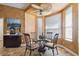 Bright breakfast nook featuring a glass table set beneath an ornate ceiling fan and multiple windows at 3402 Stonebridge Trl, Valrico, FL 33596