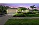 Well-maintained home exterior showcasing lush landscaping, a two-car garage, and a paver driveway at 3402 Stonebridge Trl, Valrico, FL 33596