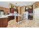 Well-lit kitchen featuring tile floors, white countertops, and a cozy breakfast bar with seating at 3402 Stonebridge Trl, Valrico, FL 33596