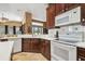 A kitchen featuring essential appliances, wooden cabinetry, and white countertops, creating a functional space at 3402 Stonebridge Trl, Valrico, FL 33596