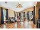 Spacious living room with hardwood floors, a leather sofa, and plentiful natural light from multiple windows at 3402 Stonebridge Trl, Valrico, FL 33596