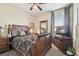Cozy main bedroom with wooden furniture, decorative pillows, and natural light from the window at 3402 Stonebridge Trl, Valrico, FL 33596