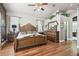 Ornate primary bedroom with hardwood floors, a decorative headboard, and ample space for a full dresser at 3402 Stonebridge Trl, Valrico, FL 33596