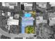 An aerial view of the property showcasing the pool, patio, and backyard entertainment area at 3485 Floral Dr, Largo, FL 33771