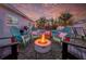 Charming backyard featuring a cozy fire pit with Adirondack chairs and string lights for evening enjoyment at 3485 Floral Dr, Largo, FL 33771