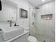 Modern bathroom featuring a square vessel sink, quartz counters and a glass enclosed shower with marbled tile at 3485 Floral Dr, Largo, FL 33771