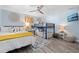 Light-filled bedroom features a queen bed, bunk beds, decor art, ceiling fan, and wood-look flooring at 3485 Floral Dr, Largo, FL 33771