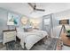 Relaxing bedroom features a queen bed, stylish accents, ceiling fan, and light-filled window with curtains at 3485 Floral Dr, Largo, FL 33771