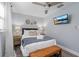 Comfortable bedroom with queen bed, ceiling fan, area rug, bedside tables, and wall mounted TV at 3485 Floral Dr, Largo, FL 33771