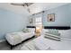 Comfortable bedroom with two twin beds, ceiling fan, window, and stylish decor at 3485 Floral Dr, Largo, FL 33771