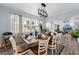Elegant dining room featuring a wooden table, white chairs, and natural lighting at 3485 Floral Dr, Largo, FL 33771