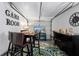 Finished garage converted into a game room featuring a high top table and wall art at 3485 Floral Dr, Largo, FL 33771