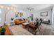 Open-concept living room featuring modern decor, hardwood floors, contemporary lighting and neutral wall paint at 3485 Floral Dr, Largo, FL 33771