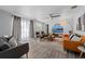 Bright living room featuring modern furnishings, a ceiling fan, and a decorative lighting fixture at 3485 Floral Dr, Largo, FL 33771