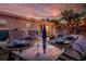 Elegant patio dining set with place settings, perfect for outdoor entertaining beneath string lights at 3485 Floral Dr, Largo, FL 33771