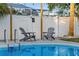 Relaxing poolside featuring Adirondack chairs and new pool at 3485 Floral Dr, Largo, FL 33771