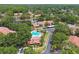 Aerial view showcasing a community pool, townhomes and lush surroundings at 3505 Tarpon Woods Blvd # P404, Palm Harbor, FL 34685