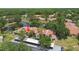 Enjoy an aerial view of condo community nestled among trees and a serene pond at 3505 Tarpon Woods Blvd # P404, Palm Harbor, FL 34685
