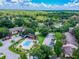 Aerial community view of lush landscape, community pool, and residential buildings at 3505 Tarpon Woods Blvd # P404, Palm Harbor, FL 34685