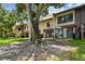 Charming condo features a cozy patio area with lush green lawn and mature trees at 3505 Tarpon Woods Blvd # P404, Palm Harbor, FL 34685