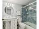 Bathroom with white vanity, modern lighting and blue tiled shower at 3505 Tarpon Woods Blvd # P404, Palm Harbor, FL 34685