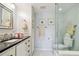This bathroom features white cabinetry, a dark countertop, and a sleek glass shower at 3505 Tarpon Woods Blvd # P404, Palm Harbor, FL 34685